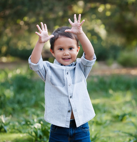 boy holding up hands