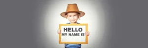 Embedded desk name plate featured image of a little girl holding a hello my name is sign.