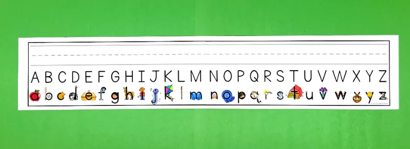 Printable alphabet strip with handwriting line, capital letters, and lowercase embedded mnemonics.