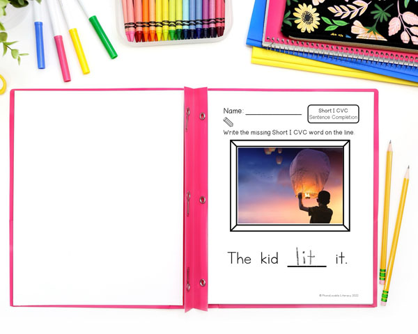 Printed dictation page of boy holding a sky lantern and sentence The kid lit it.