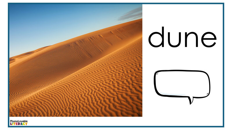 Structured literacy digital slide with a picture of a sand dune and the word dune and a speech bubble next to it.